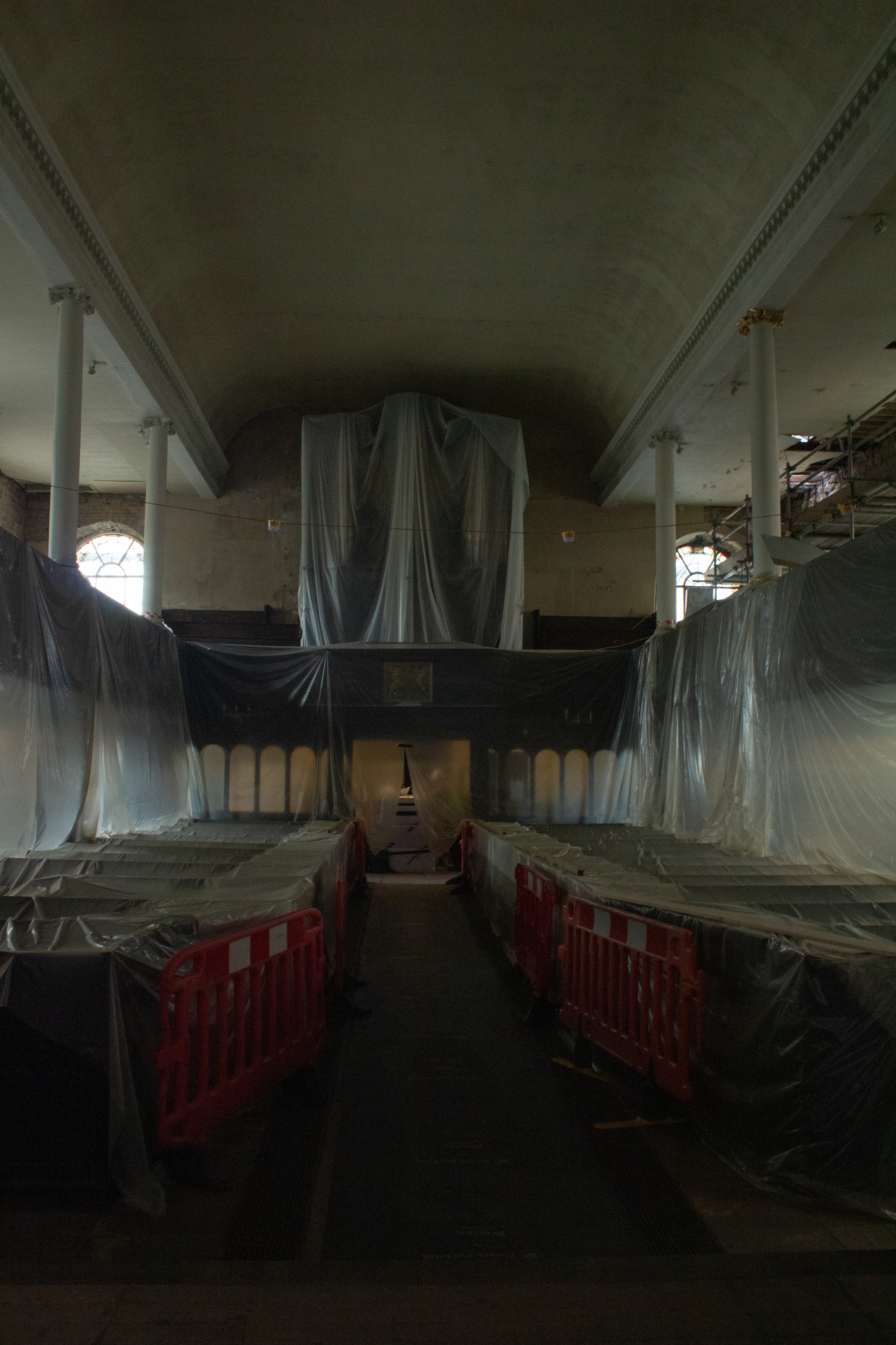 Interior of St. Johns covered in white protective tarps