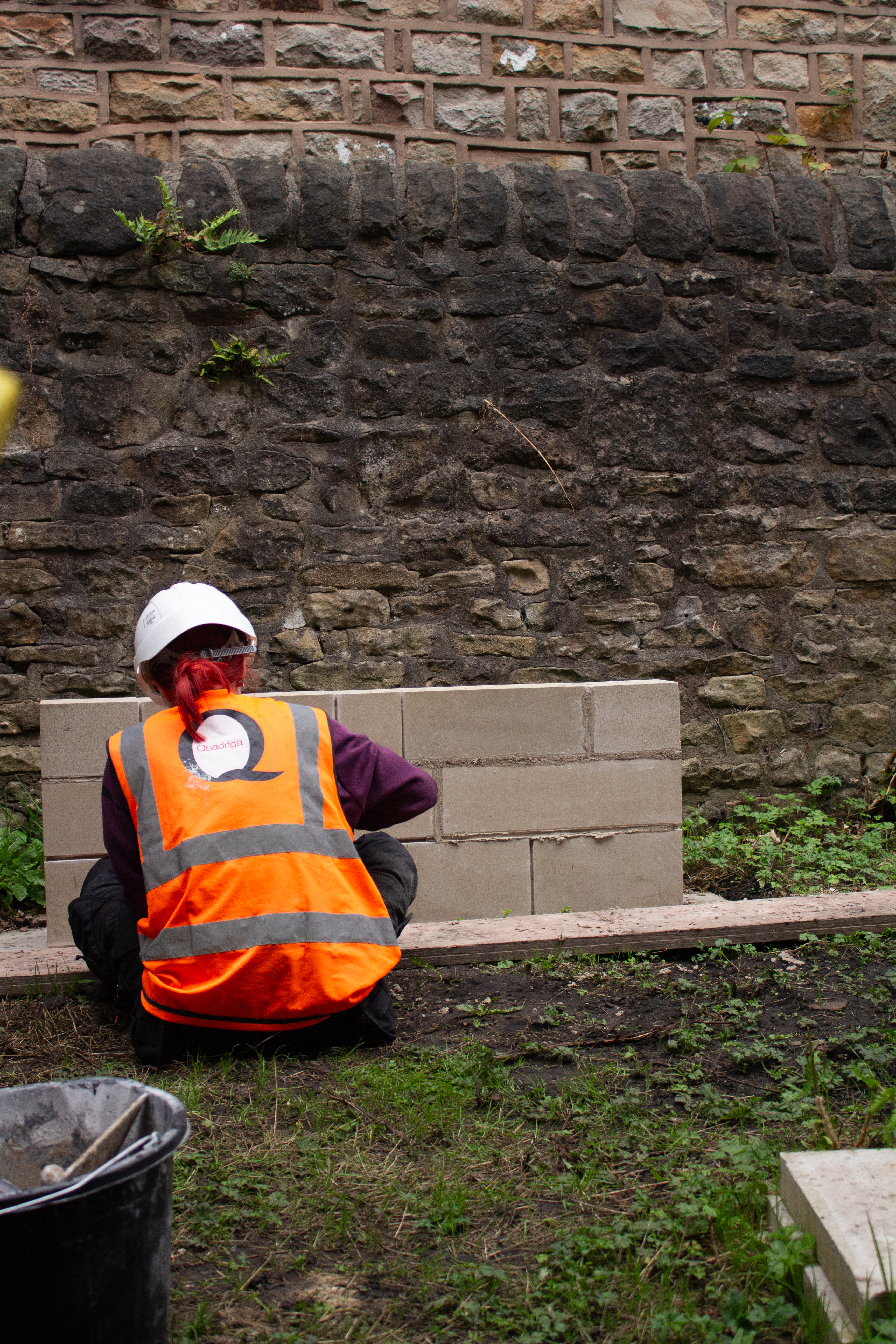 Apprentice applying lime mortar.